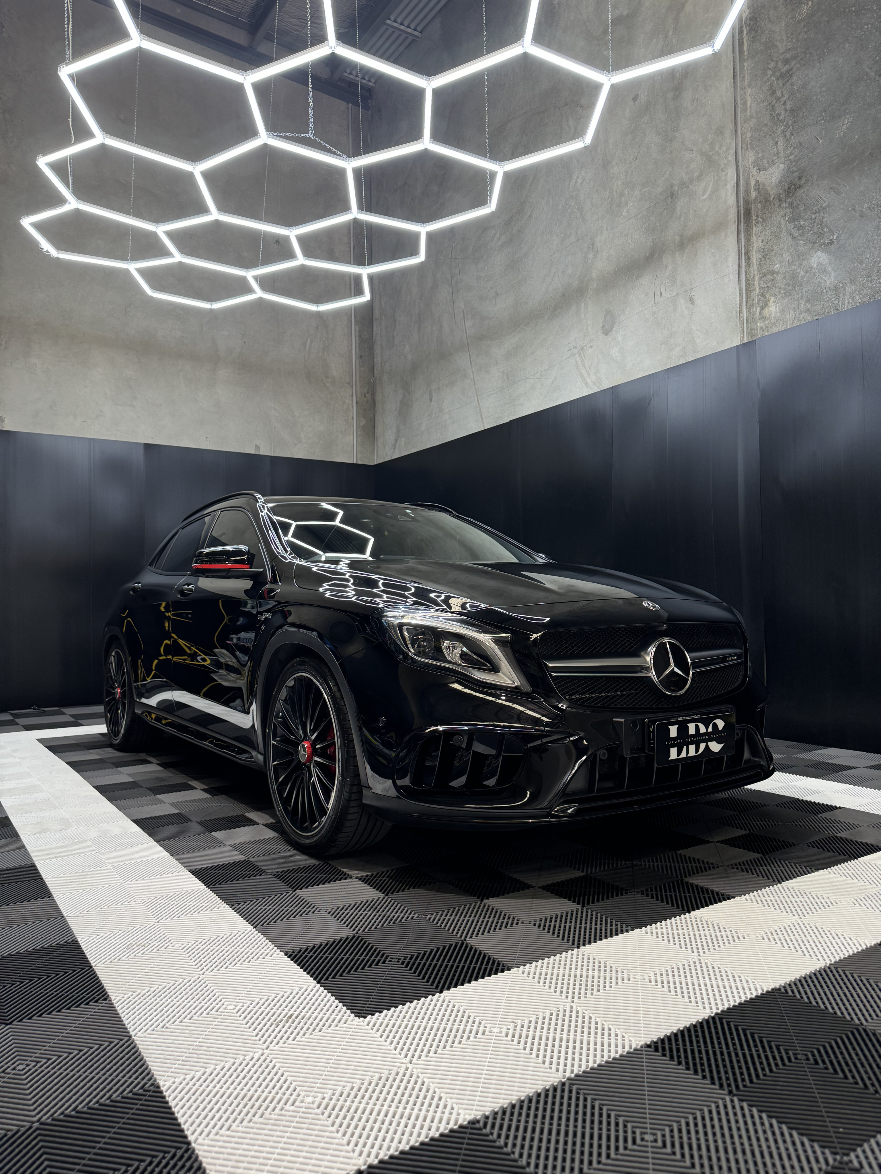 Black and white photo of a women performing modern dance on a dark background.