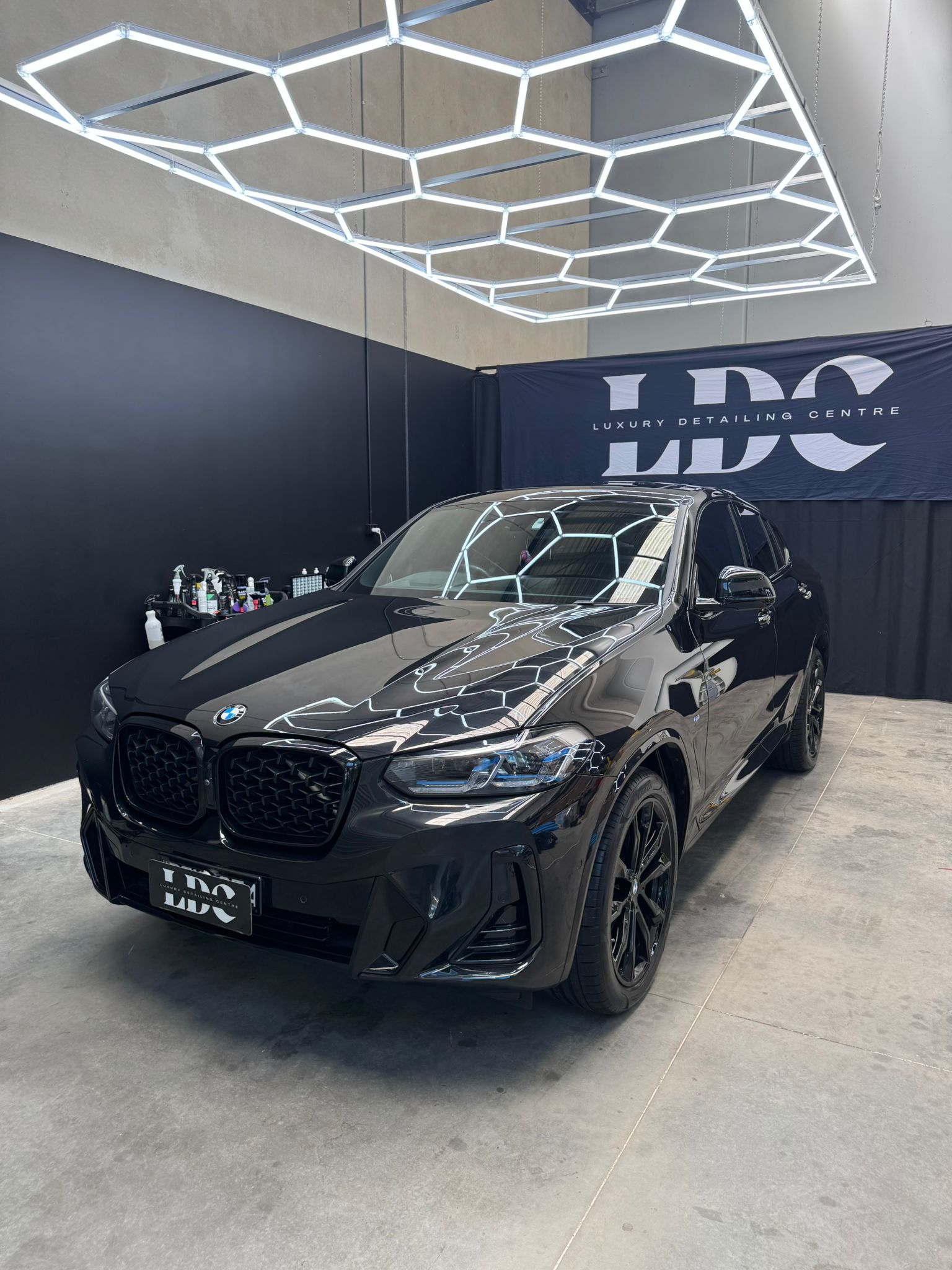 Black and white photo of a women performing modern dance on a dark background.
