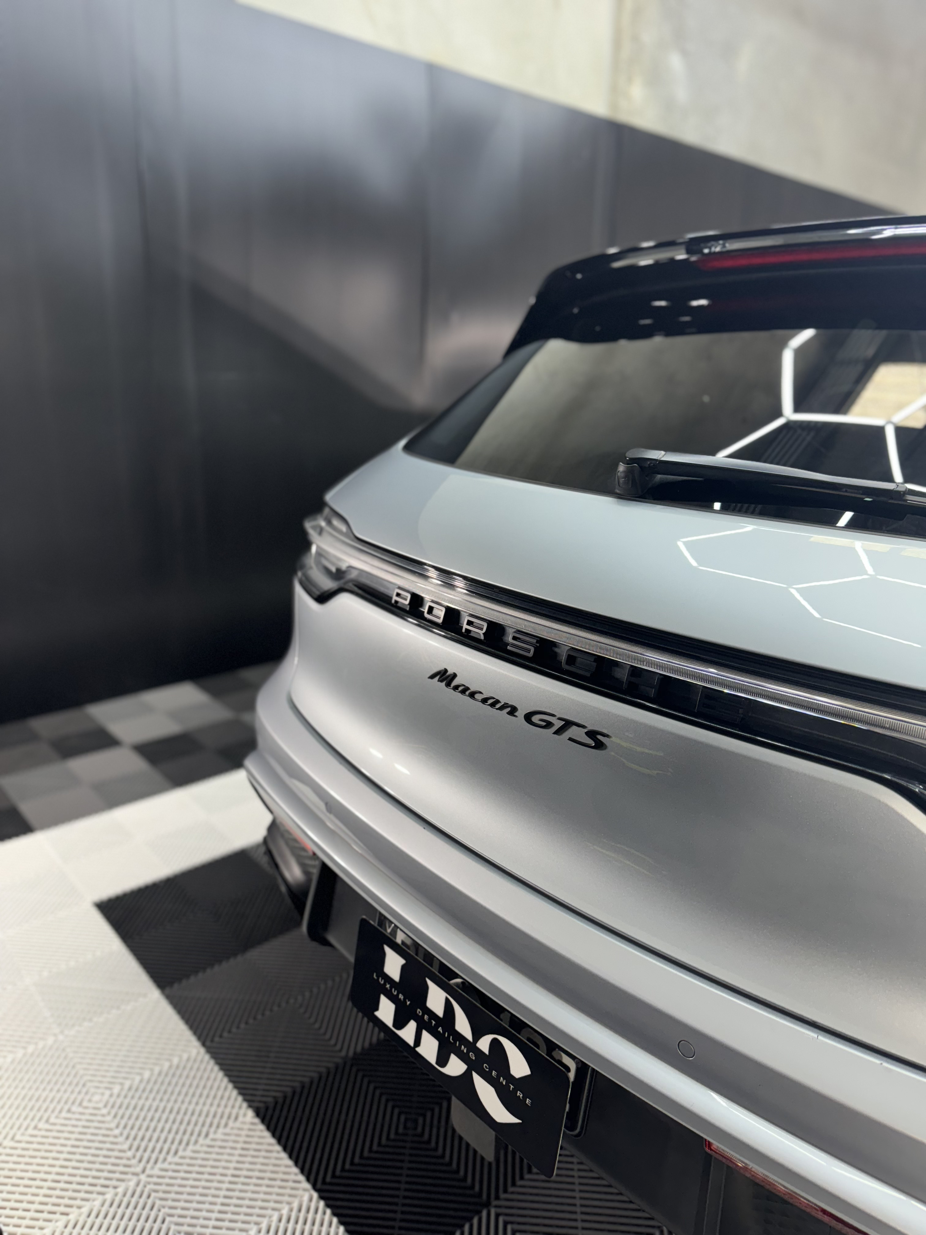 Black and white photo of a women performing modern dance on a dark background.